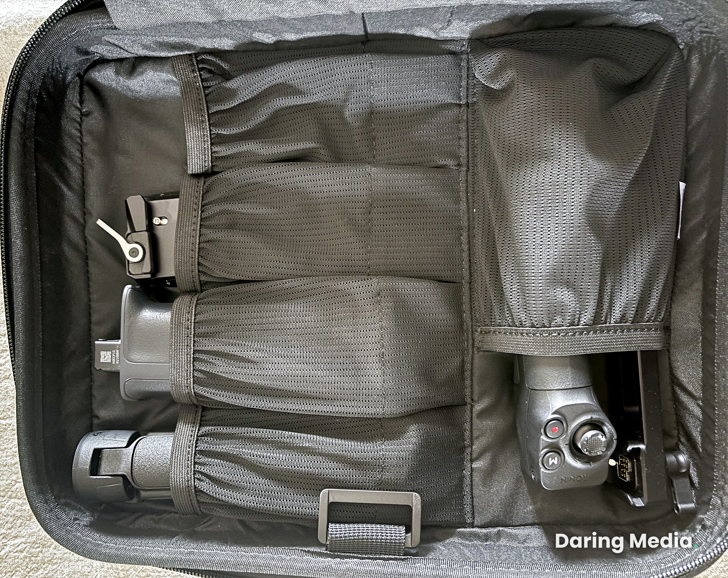 DJI RS 5 Combo accessories compartment showing the briefcase handle, tripod and remote packed into the case