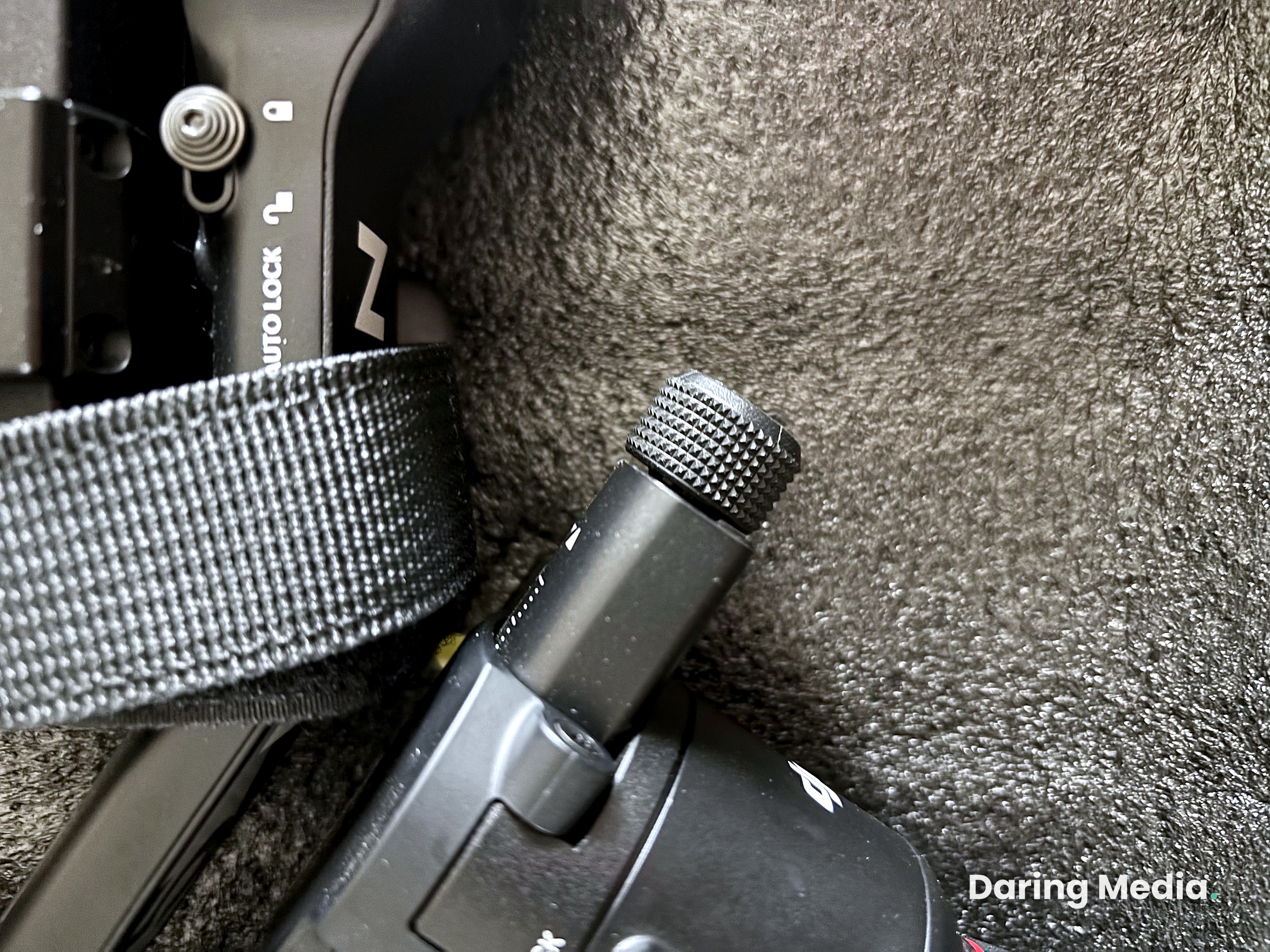Close-up of the DJI RS 5 fine-tuning balance knob and axis lock mechanism inside the carry case